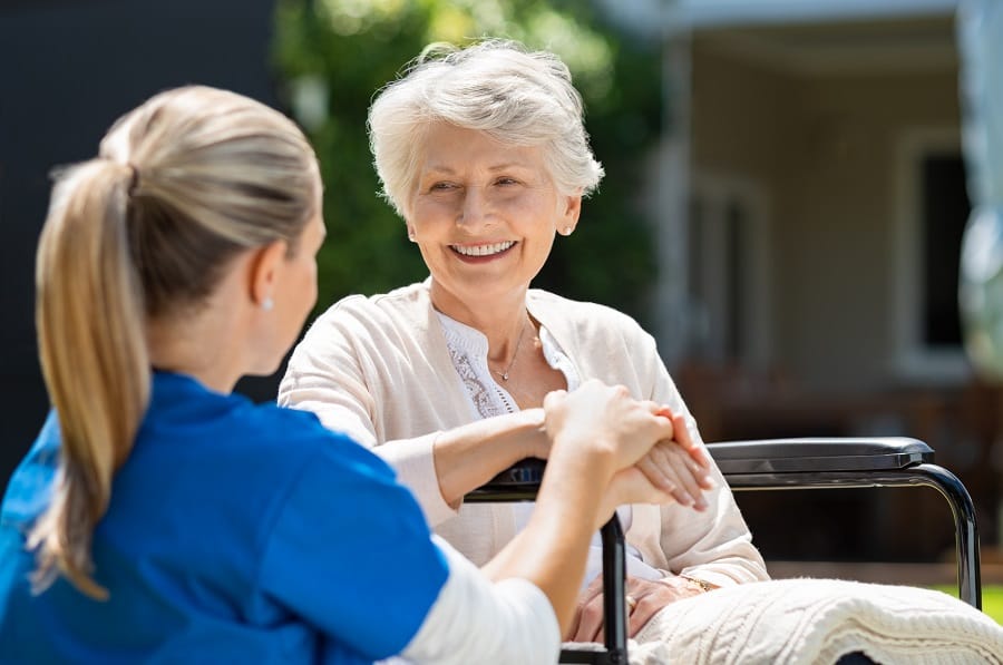 Nurse takes care of old patient Minimising Restrictive Practices in Aged Care